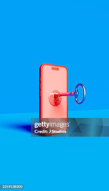 physical key inserted into a red smartphone representing mobile device encryption and user access control - phone security code stock pictures, royalty-free photos & images