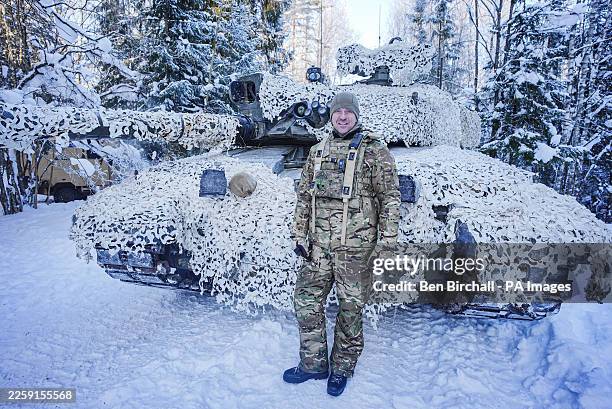 Commanding Officer Royal Tank Regiment Lieutenant Colonel Mark Luson with a Challenger 2 main battle tank in arctic camouflage on the Tapa range in...