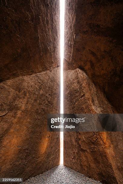 light comes in through the rock crevice - canyon stock pictures, royalty-free photos & images