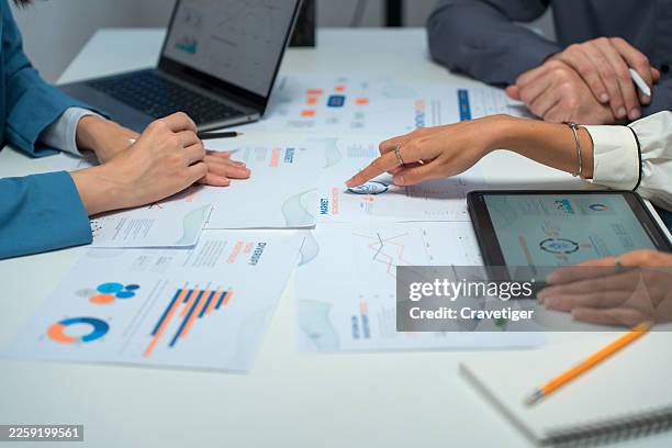 hands pointing at cash flow forecasts. - part exchange stock pictures, royalty-free photos & images