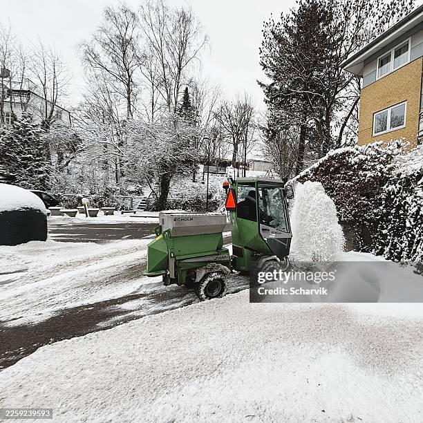 snow sweeper clearing streets in holte, a copenhagen suburb, man driving amid winter weather - condition stock pictures, royalty-free photos & images