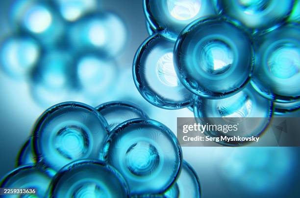close-up of two transparent molecules on a blue background. - código del genoma humano fotografías e imágenes de stock