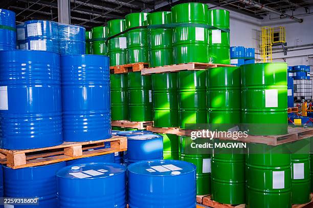 chemical plant warehouse full of colorful hugh barrels - oil drum stock pictures, royalty-free photos & images