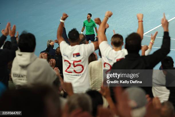 Novak Djokovic of Serbia celebrates a point as his fans cheer in the Men's Singles Final against Carlos Alcaraz of Spain during day 15 of the 2026...