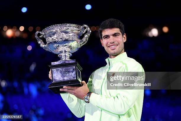 Carlos Alcaraz of Spain poses with the Norman Brookes Challenge Cup at the presentation ceremony after his victory in the Men's Singles Final against...