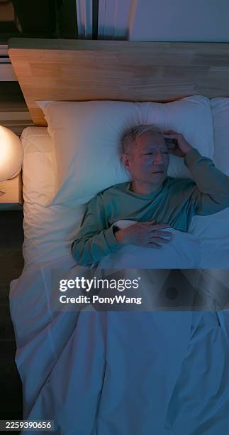 asian elderly man suffer from insomnia home - soundproof room stock pictures, royalty-free photos & images