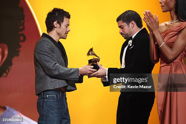 Harry Styles presents the Album of the Year award to Bad Bunny for "DeBÍ TiRAR MáS FOToS" onstage during the 68th GRAMMY Awards at Crypto.com Arena...