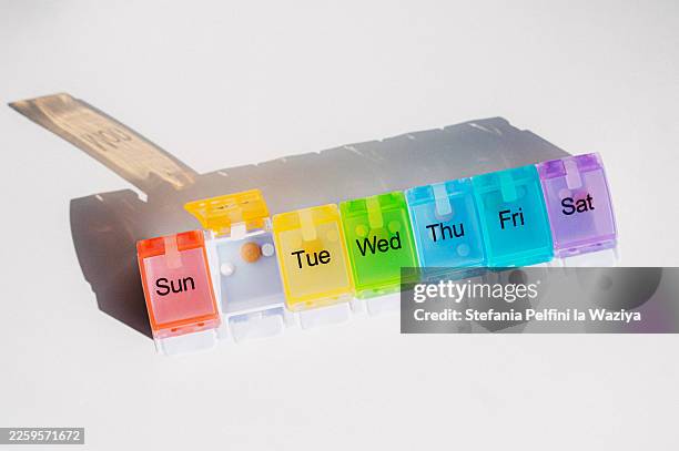 colorful weekly pill organizer - pill organizer stock pictures, royalty-free photos & images