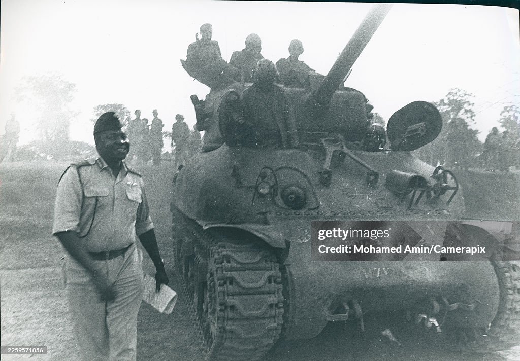 Amin Loading President of Uganda and military officer Idi Amin walks besides a ...