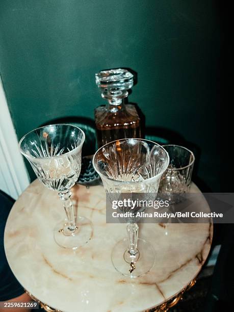 glassware and bottle on marble table - decanter stock pictures, royalty-free photos & images