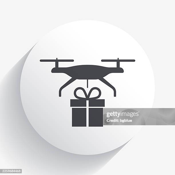 delivery drone with gift. icon on circle button with long shadow - drone package stock illustrations