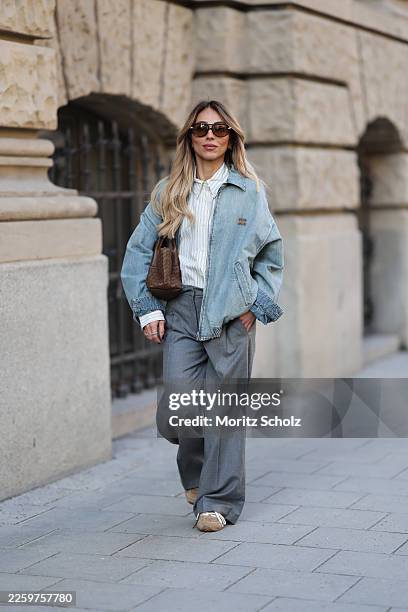 Oeznur Sinani alias Sinperi is wearing a light blue zip-up jacket by Miu Miu; a white shirt with blue stripes by Miu Miu; a wide-leg grey trousers by...