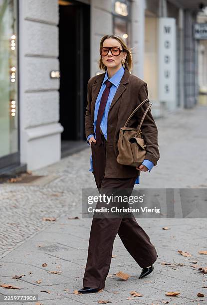 Tina Haase wears suede brown blazer My essential wardrobe, Savile Row blue shirt and tie, Frankieshop brown suit pants, Potamy pointed high heels,...