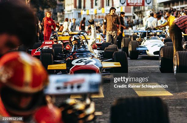 David Purley raises a hand whilst sat in his Brabham BT28 Ford/Holbay on the grid at the Formula 3 Monaco Grand Prix at Circuit de Monaco in Monte...