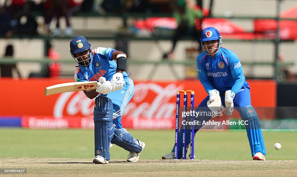 Mahbob U Aaron George of India plays a shot as Mahboob Khan of Afghanistan ...