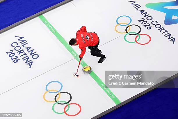 Brett Gallant of Team Canada sweeps the stone during a training session on day minus two of the Milano Cortina 2026 Winter Olympic games at Cortina...