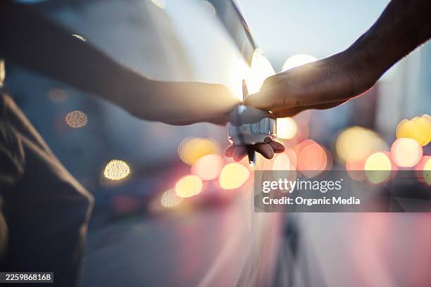 hand opening car door with city bokeh - car door stock pictures, royalty-free photos & images