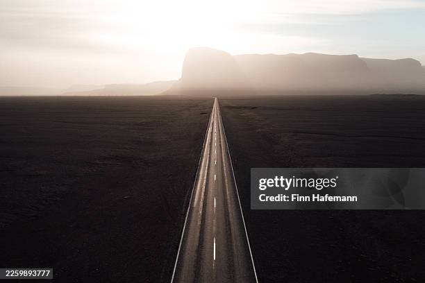 road through volcanic desert landscape in southern iceland - abandoned stock pictures, royalty-free photos & images