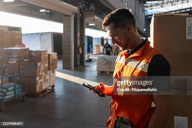 warehouse employee using his cell phone on his break - loading dock stock pictures, royalty-free photos & images