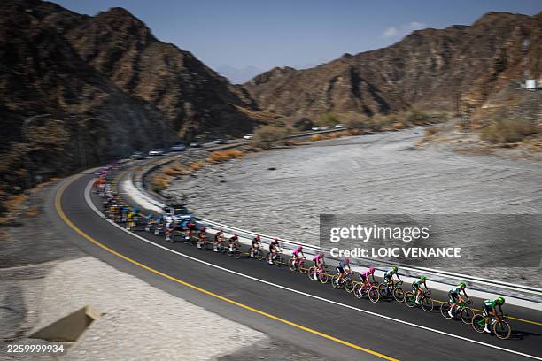 This photograph taken by slow shutter speed effect shows the pack riding during the 2nd stage of the Tour of Oman cycling race from Al Rustaq Fort to...