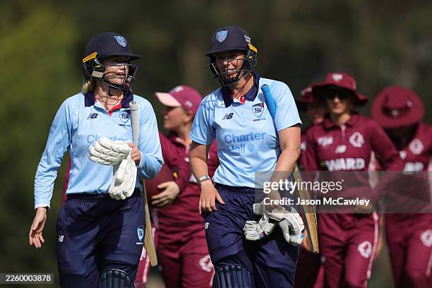 Lauren Cheatle and Sam Bates of the Breakers walk from the field after winning the WNCL match between New South Wales Breakers and Queensland Fire at...