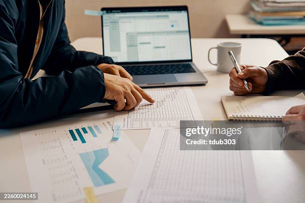 close up shot of an accountant or financial advisor having casual meeting with client - annual event stock pictures, royalty-free photos & images