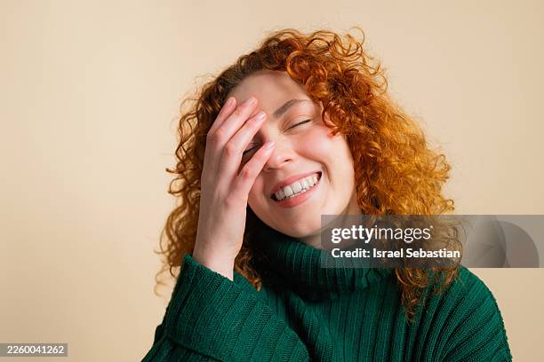 young woman covering face laughing and smiling - shy stock pictures, royalty-free photos & images