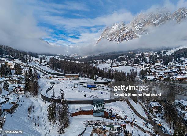An aerial view shows the Cortina Sliding Centre Eugenio Monti, the bobsleigh, skeleton and luge venue built for the Milano-Cortina 2026 Winter...