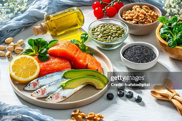 healthy ingredients rich in omega-3 unsaturated fatty acid and vitamin d. products for a diet that boost the inmune system and help to archive skin elasticity. nutrition and wellbeing - omega 3 stockfoto's en -beelden
