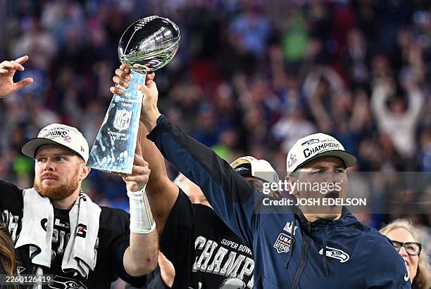 Seattle Seahawks' quarterback Sam Darnold and Seattle Seahawks' head coach Mike Macdonald celebrate with the Vince Lombardi Trophy after the Seattle...