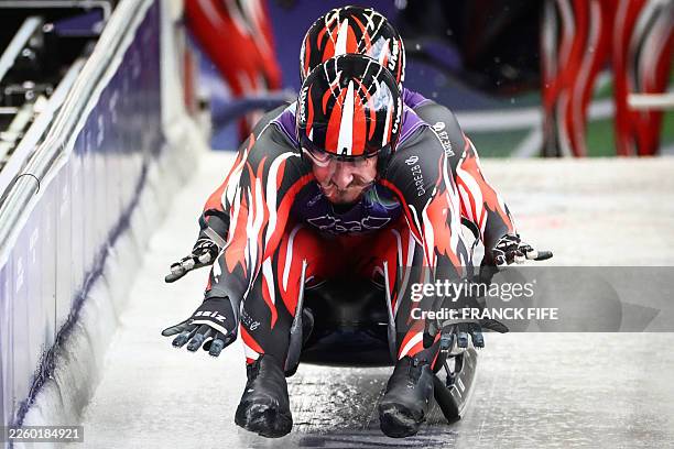 Austria's Thomas Steu and Austria's Thomas Steu take part the start in the luge men's doubles training session at Cortina Sliding Centre during the...