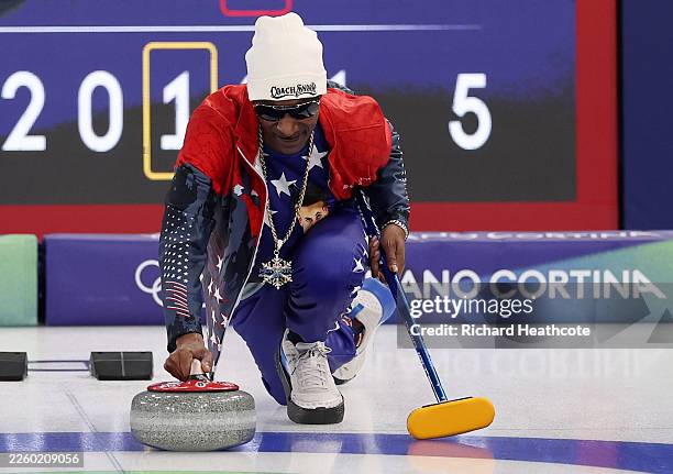 Snoop Dogg, Rapper and Honorary Coach of Team USA, is seen throwing a stone on the ice following the Curling Mixed Doubles Round Robin match between...
