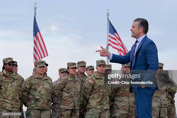 Secretary of War Pete Hegseth address a group of National Guard troops before administering their re-enlistment ceremony at the base of the...