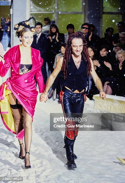 Model walks the runway with designer John Galliano in the John Galliano Fall 1995 RTW Paris fashion show.