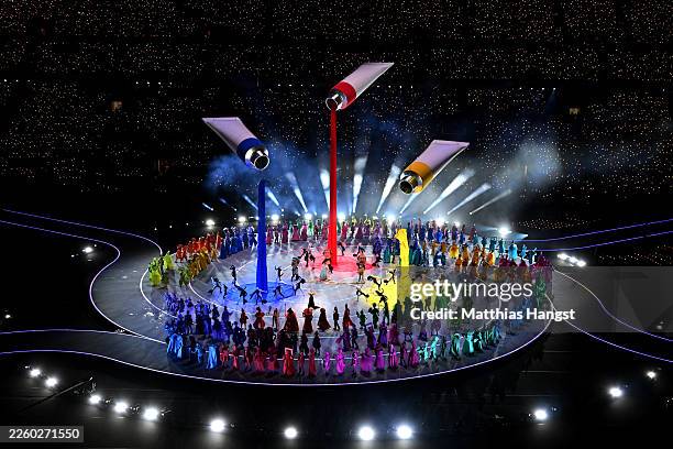 General view of a parade of performers dressed as symbols of Italian imagination and creativity during the opening ceremony of the Milano Cortina...