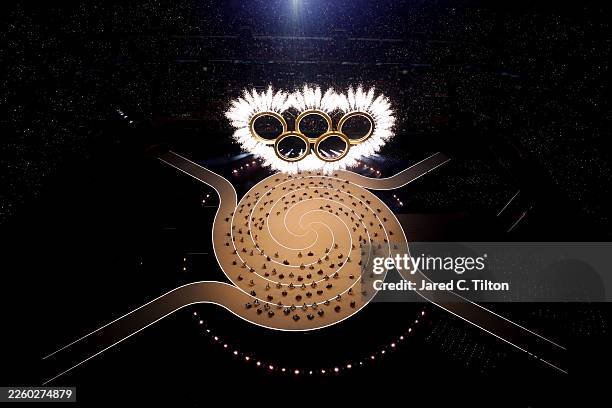 The Olympic rings come together as a fireworks display is seen during the opening ceremony of the Milano Cortina 2026 Winter Olympics at San Siro...