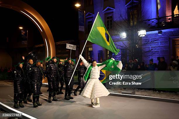 Flagbearer Nicole Rocha Silveira of Team Brazil enters with the team into the stadium during the opening ceremony of the Milano Cortina 2026 Winter...