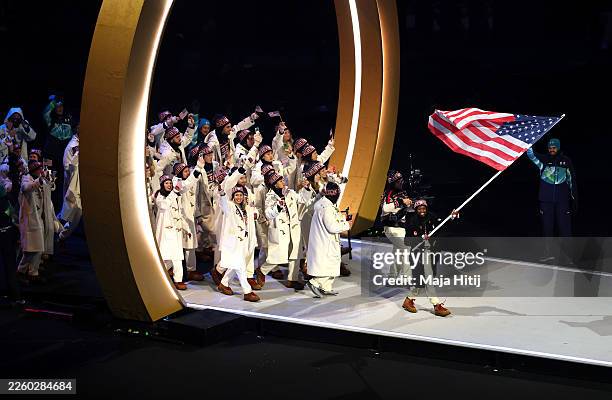 Flagbearer Erin Jackson of Team United States enters the athlete parade with her team during the opening ceremony of the Milano Cortina 2026 Winter...