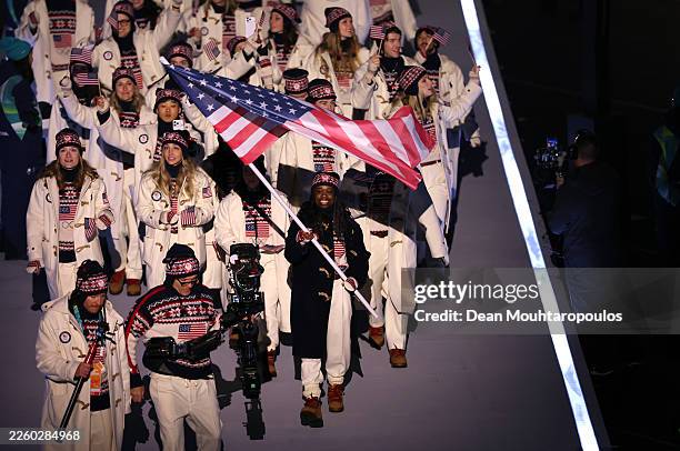 Flagbearer Erin Jackson of Team United States leads the team in the parade during the opening ceremony of the Milano Cortina 2026 Winter Olympics at...