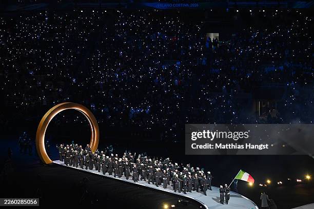 Flagbearers Arianna Fontana and Federico Pellegrino of Team Italy enter with the team during the opening ceremony of the Milano Cortina 2026 Winter...