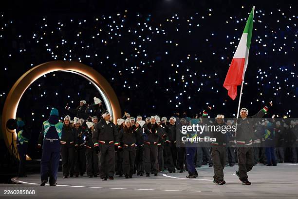 Flagbearers Arianna Fontana and Federico Pellegrino of Team Italy lead the team in the athletes' parade during the opening ceremony of the Milano...