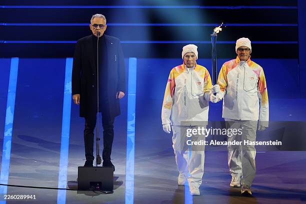 Andrea Boccelli performs as the Olympic flame is carried in the stadium during the opening ceremony of the Milano Cortina 2026 Winter Olympics at San...