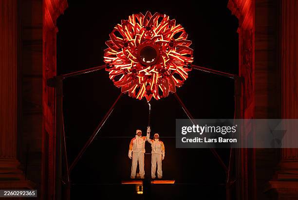 Torchbearers Deborah Compagnoni and Alberto Tomba lights the Olympic cauldron at the Arco della Pace during the opening ceremony of the Milano...