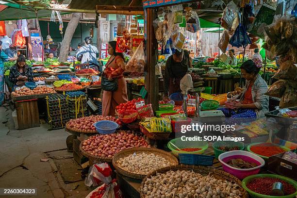 Corner stall selling vegetables at Mann Myo Market. Mann Myo Market in Mandalay, Myanmar, is a lively local marketplace that reflects daily life and...