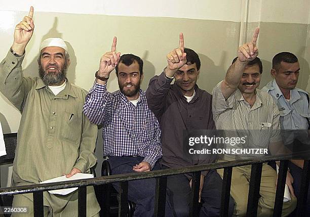 The head of the Islamic Movement in Israel, Sheikh Raed Salah , and his comrades point upwards to show their trust in God as they appear 24 June 2003...