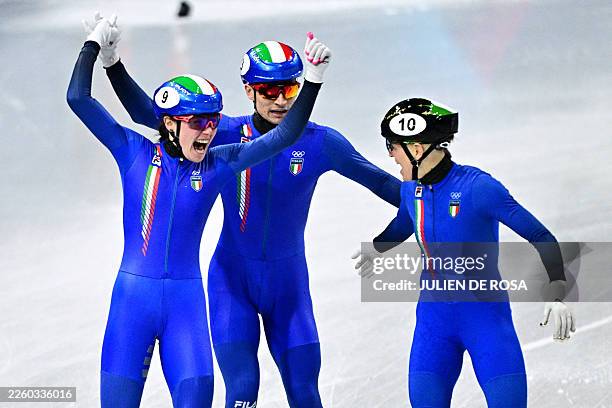 Team Italy's Elisa Confortola, Pietro Sighel and Arianna Fontana celebrate after winning gold in the short track speed skating mixed team relay final...