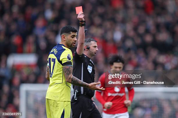 Cristian Romero of Tottenham Hotspur reacts as he is shown a red card by referee Michael Oliver during the Premier League match between Manchester...