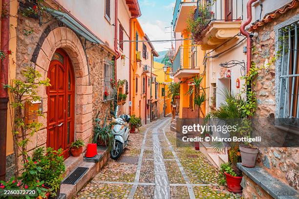 charming narrow street on colorful mediterranean alley in scilla, calabria, italy - historic building stock pictures, royalty-free photos & images