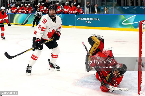 Saskia Maurer of Team Switzerland makes a save as Brianne Jenner of Team Canada looks on in the first period during the Women's Preliminary Round...