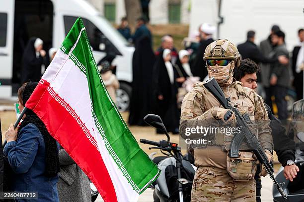 Member of the security forces stands guard during a rally marking the 47th anniversary of the 1979 Islamic revolution in Tehran on February 11, 2026....